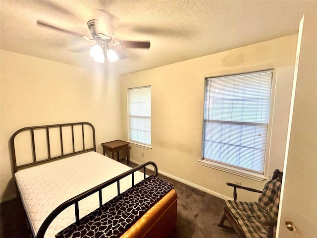 224 Crooked Hollow Dr, Elgin, TX 78621 - bedroom with dark colored carpet, ceiling fan, and a textured ceiling
