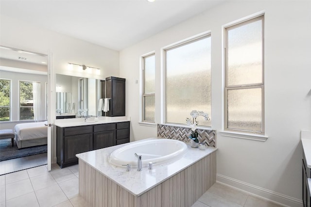 4108 Logan Ridge Dr, Cedar Park, TX 78613 - full bath featuring vanity, a garden tub, tile patterned flooring, backsplash, and connected bathroom