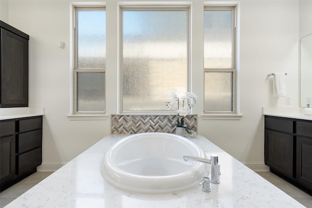4108 Logan Ridge Dr, Cedar Park, TX 78613 - full bathroom featuring vanity, a garden tub, and decorative backsplash