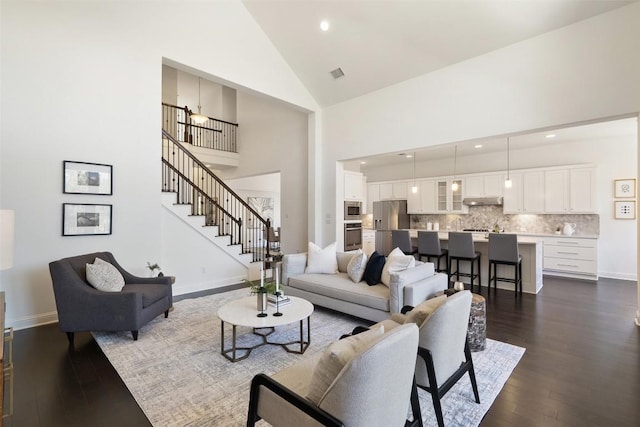 4108 Logan Ridge Dr, Cedar Park, TX 78613 - living area featuring dark wood-style floors, high vaulted ceiling, stairs, and recessed lighting