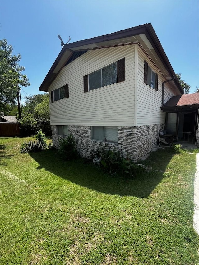 6005 Walnut Hills Dr, Austin, TX 78723 - view of home's exterior with a yard and stone siding