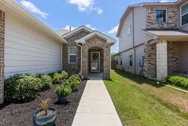 13911 Macquarie Dr, Pflugerville, TX 78660 - doorway to property featuring a lawn and brick siding