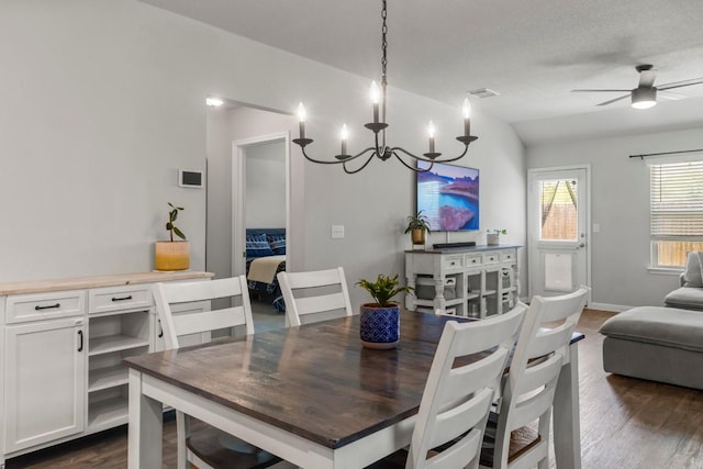 13911 Macquarie Dr, Pflugerville, TX 78660 - dining area featuring dark wood finished floors, a chandelier, and a ceiling fan