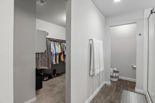 13911 Macquarie Dr, Pflugerville, TX 78660 - bathroom featuring a stall shower, wood finished floors, and a spacious closet