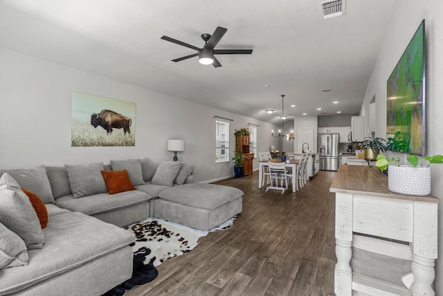 13911 Macquarie Dr, Pflugerville, TX 78660 - living area with ceiling fan, dark wood finished floors, recessed lighting, and a chandelier