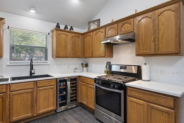 6001 Andross Ct, Hutto, TX 78634 - kitchen featuring stainless steel gas stove, under cabinet range hood, wine cooler, vaulted ceiling, and dark wood-style floors