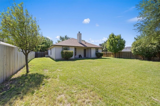 6001 Andross Ct, Hutto, TX 78634 - rear view of property with a fenced backyard and a chimney