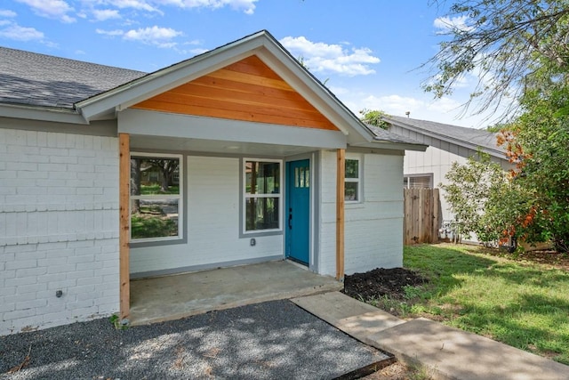 7913 W Gate Blvd Unit A, Austin, TX 78745 - view of exterior entry featuring brick siding and a shingled roof