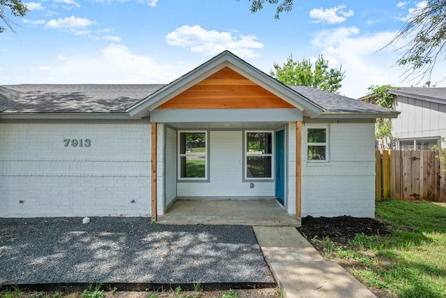 7913 W Gate Blvd Unit A, Austin, TX 78745 - ranch-style home featuring brick siding, a porch, and roof with shingles
