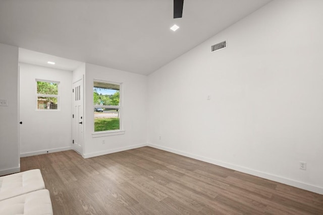 7913 W Gate Blvd Unit A, Austin, TX 78745 - unfurnished living room featuring wood finished floors, a ceiling fan, and lofted ceiling