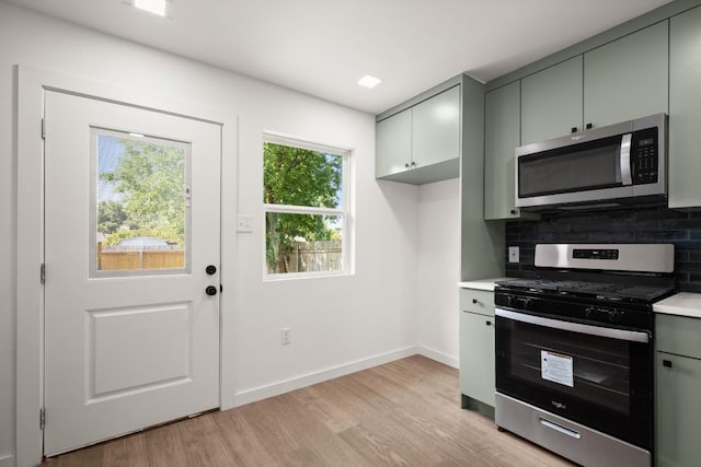 7913 W Gate Blvd Unit A, Austin, TX 78745 - kitchen featuring stainless steel appliances, gray cabinetry, light countertops, and tasteful backsplash