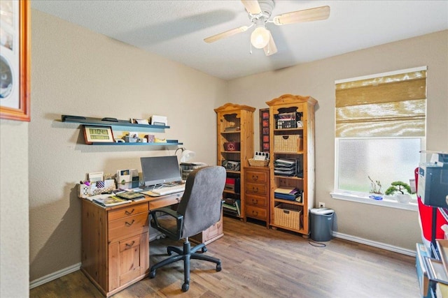 office area with wood finished floors and ceiling fan