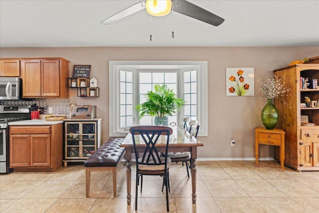 dining room with ceiling fan and light tile patterned floors