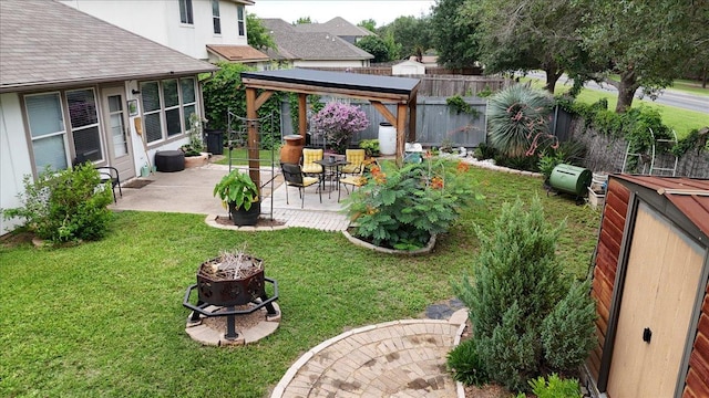 fenced backyard featuring a gazebo, a patio, and a fire pit