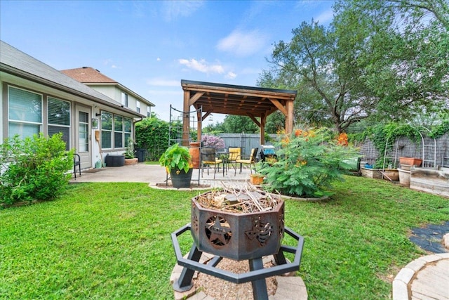 fenced backyard featuring a patio area and a fire pit
