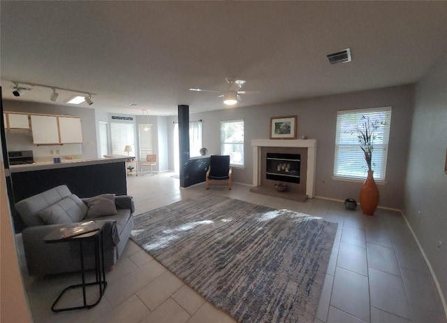 1805 Timber Ridge Dr, Cedar Park, TX 78613 - living area featuring light tile patterned floors, ceiling fan, track lighting, and a glass covered fireplace