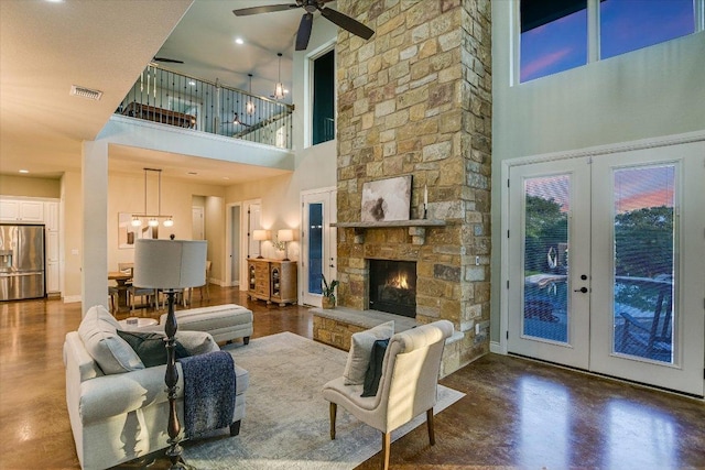 4275 Fm 3405, Georgetown, TX 78633 - living room with a high ceiling, french doors, finished concrete floors, a ceiling fan, and a fireplace