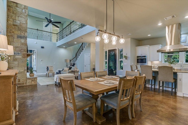 4275 Fm 3405, Georgetown, TX 78633 - dining room with concrete floors, a ceiling fan, a high ceiling, and stairway