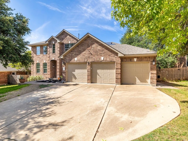 2407 Silver Spur Ln, Leander, TX 78641 - view of front of house with an attached garage, brick siding, and driveway