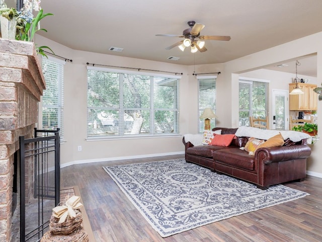 2407 Silver Spur Ln, Leander, TX 78641 - living room featuring ceiling fan, wood finished floors, and a stone fireplace