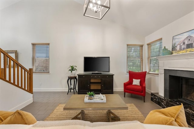 8600 Cima Oak Ln Unit A15, Austin, TX 78759 - tiled living area featuring high vaulted ceiling, stairs, a chandelier, and a tile fireplace