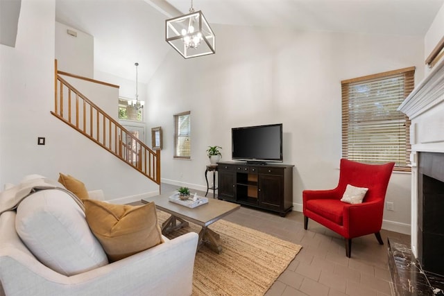 8600 Cima Oak Ln Unit A15, Austin, TX 78759 - tiled living room with a chandelier, stairway, high vaulted ceiling, and a fireplace