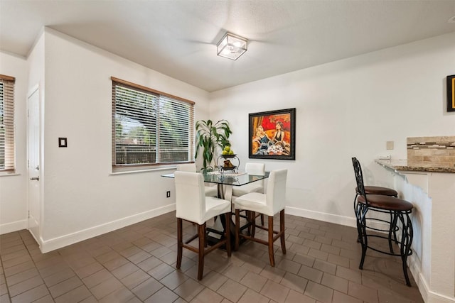 8600 Cima Oak Ln Unit A15, Austin, TX 78759 - dining room featuring dark tile patterned floors and baseboards