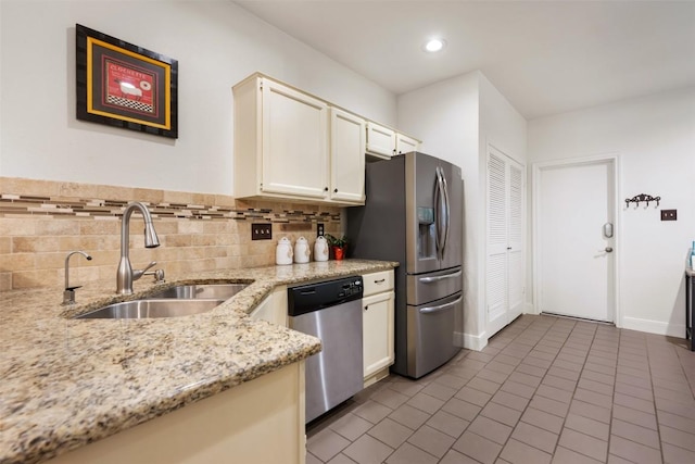8600 Cima Oak Ln Unit A15, Austin, TX 78759 - kitchen featuring appliances with stainless steel finishes, tile patterned floors, light stone countertops, white cabinets, and tasteful backsplash