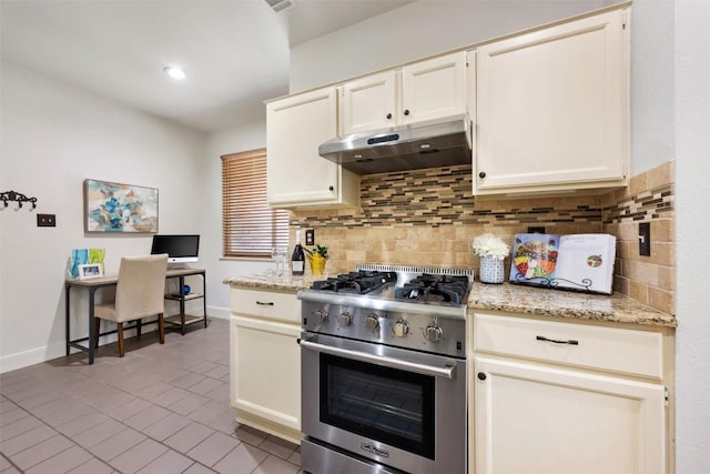8600 Cima Oak Ln Unit A15, Austin, TX 78759 - kitchen featuring high end stove, under cabinet range hood, backsplash, tile patterned flooring, and light stone countertops
