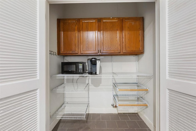 8600 Cima Oak Ln Unit A15, Austin, TX 78759 - interior space with black microwave, brown cabinetry, and tile counters
