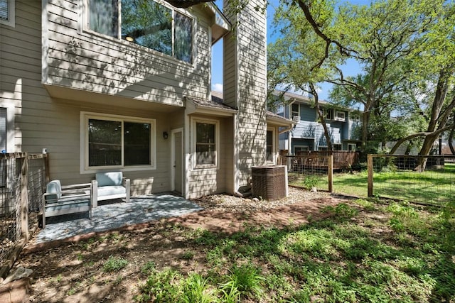 8600 Cima Oak Ln Unit A15, Austin, TX 78759 - rear view of property featuring a chimney and a patio