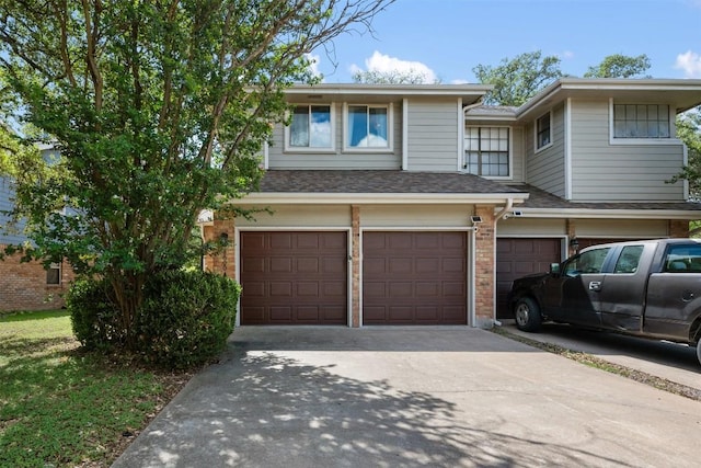 8600 Cima Oak Ln Unit A15, Austin, TX 78759 - view of front of property with an attached garage, driveway, and brick siding