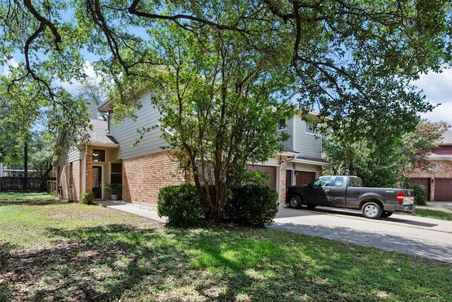 8600 Cima Oak Ln Unit A15, Austin, TX 78759 - view of side of home with brick siding, concrete driveway, and a garage