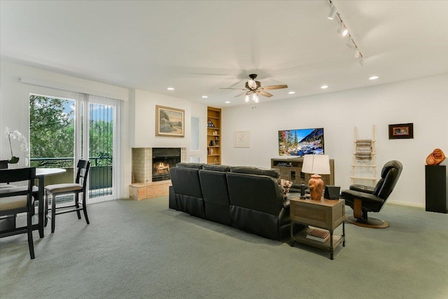 1707 Spyglass Dr Unit 41, Austin, TX 78746 - carpeted living area featuring a lit fireplace, recessed lighting, a ceiling fan, and rail lighting