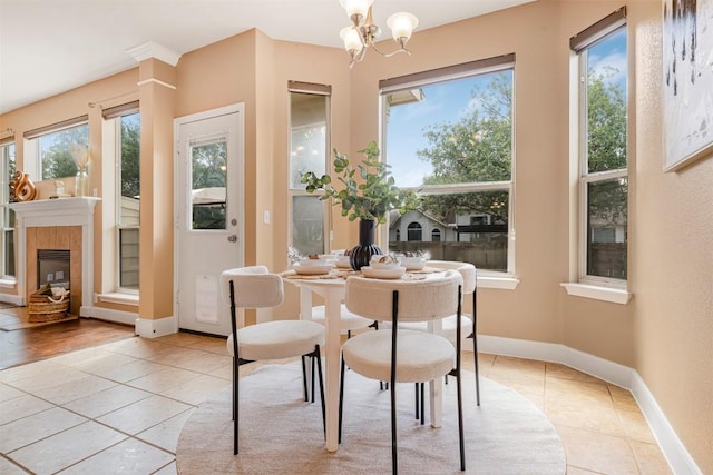 3126 Fiorellino Pl, Cedar Park, TX 78613 - dining area with light tile patterned floors, a chandelier, and a tiled fireplace