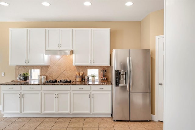 3126 Fiorellino Pl, Cedar Park, TX 78613 - kitchen featuring appliances with stainless steel finishes, under cabinet range hood, white cabinetry, dark stone countertops, and recessed lighting
