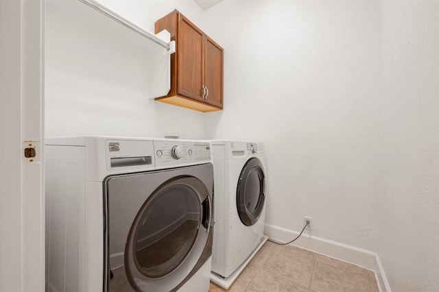3126 Fiorellino Pl, Cedar Park, TX 78613 - laundry area with cabinet space, washer and clothes dryer, and light tile patterned floors