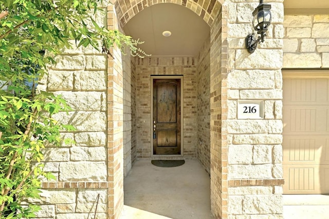 216 Tovas Secret Cv, Georgetown, TX 78628 - doorway to property featuring brick siding and stone siding