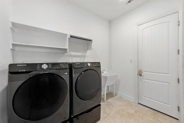 216 Tovas Secret Cv, Georgetown, TX 78628 - washroom with separate washer and dryer and baseboards