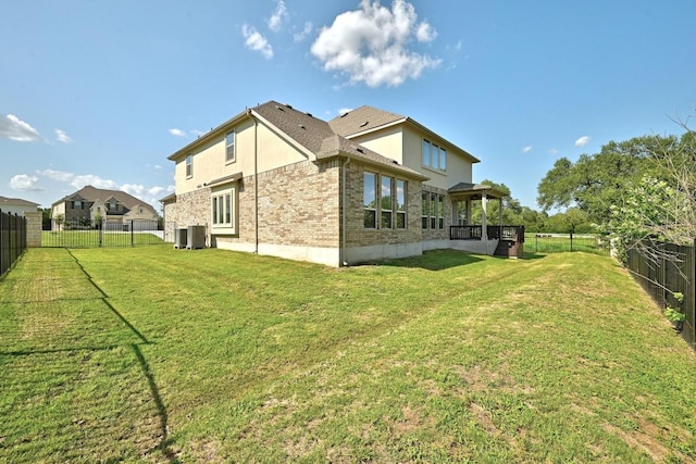 216 Tovas Secret Cv, Georgetown, TX 78628 - rear view of house with a fenced backyard, brick siding, and stucco siding