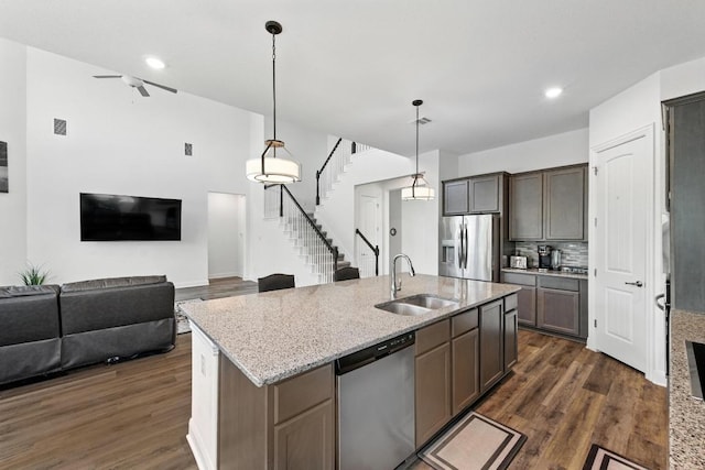 216 Tovas Secret Cv, Georgetown, TX 78628 - kitchen featuring stainless steel appliances, dark wood-type flooring, light stone counters, a ceiling fan, and recessed lighting