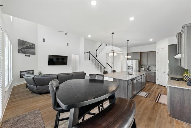 216 Tovas Secret Cv, Georgetown, TX 78628 - dining area featuring stairs, healthy amount of natural light, light wood-style floors, and recessed lighting
