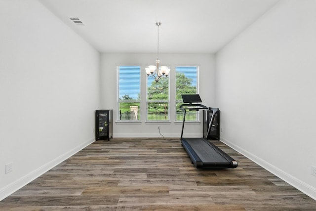 216 Tovas Secret Cv, Georgetown, TX 78628 - exercise room featuring a chandelier and wood finished floors
