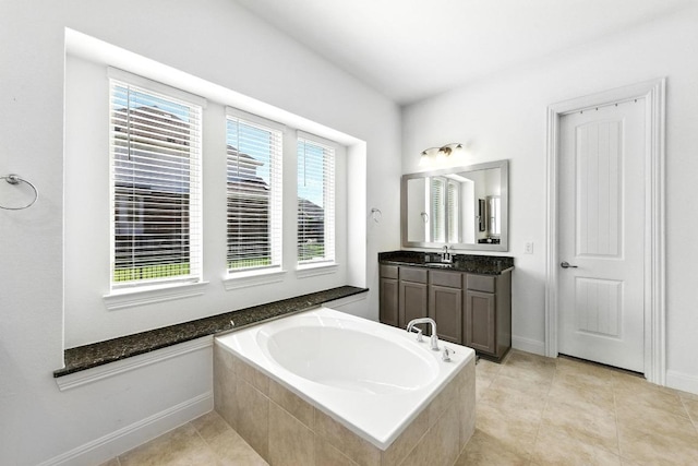 216 Tovas Secret Cv, Georgetown, TX 78628 - full bathroom featuring a garden tub, vanity, and tile patterned flooring