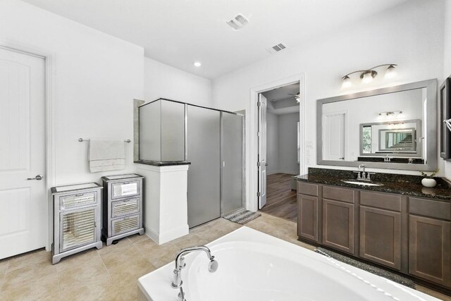 216 Tovas Secret Cv, Georgetown, TX 78628 - full bathroom featuring a stall shower, a bath, vanity, and ceiling fan