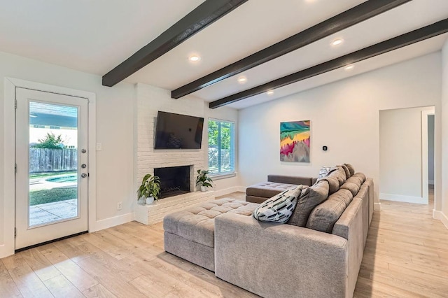 3013 Val Dr, Austin, TX 78723 - living area featuring light wood-style floors, recessed lighting, beam ceiling, and a brick fireplace