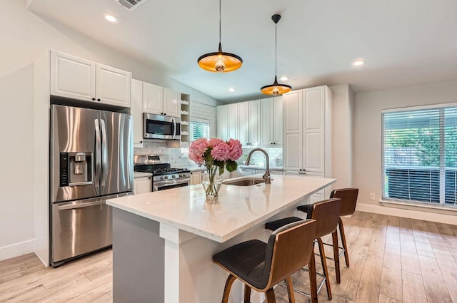 3013 Val Dr, Austin, TX 78723 - kitchen with stainless steel appliances, backsplash, light wood finished floors, white cabinets, and recessed lighting