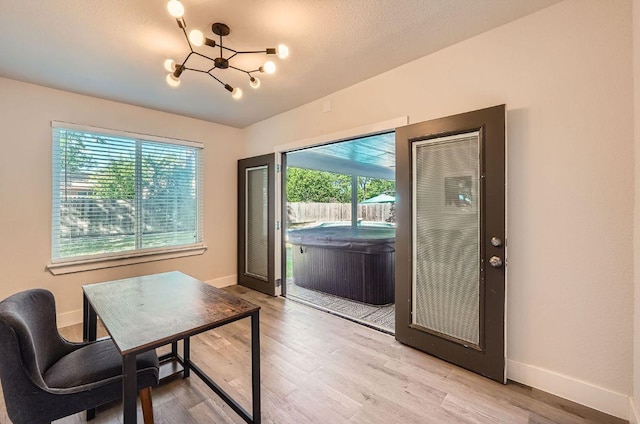 3013 Val Dr, Austin, TX 78723 - home office featuring a chandelier, plenty of natural light, and light wood-type flooring