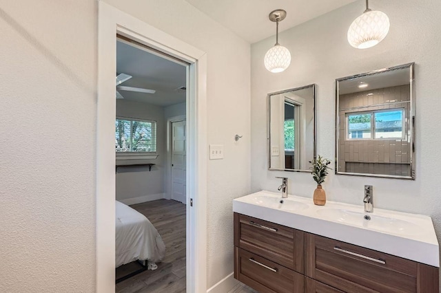 3013 Val Dr, Austin, TX 78723 - full bathroom with wood finished floors, double vanity, and plenty of natural light
