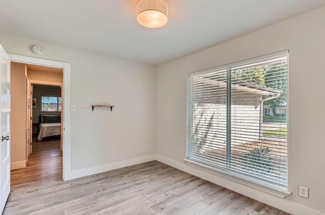 3013 Val Dr, Austin, TX 78723 - empty room featuring light wood-style flooring and a smoke detector